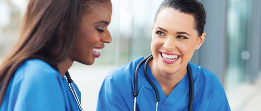 two nurses preparing for an inoculation drive and glad about their organization's vaccine management solution