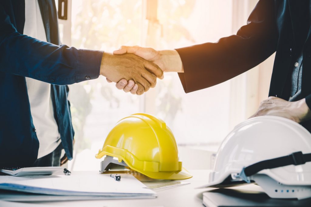 a picture of two men shaking hands to signify front and back house interaction