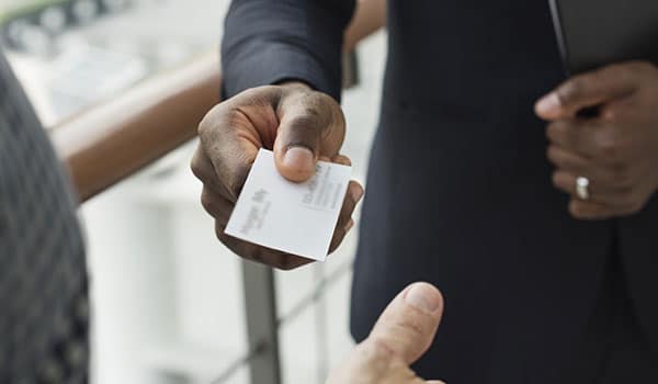 a businessman handing a business card