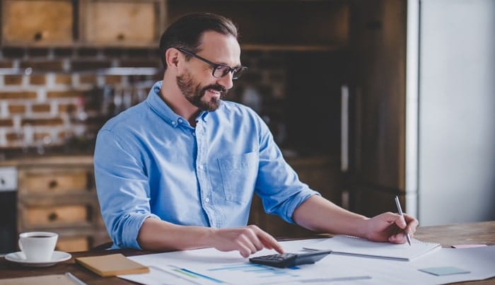 A man doing a computation for a report