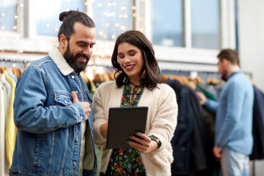 A staff assisting a customer using digital technology